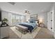 Spacious bedroom featuring a ceiling fan, large windows, and a comfortable, coordinated design at 525 Marion Hills Way, Knightdale, NC 27545