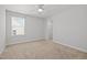 Bright bedroom with carpet, neutral walls, a ceiling fan, and a large window at 525 Marion Hills Way, Knightdale, NC 27545