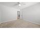 Bedroom with carpet, neutral walls, a ceiling fan, and an adjoining bathroom at 525 Marion Hills Way, Knightdale, NC 27545