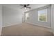 Bright bedroom with carpet, neutral walls, a ceiling fan, and two large windows at 525 Marion Hills Way, Knightdale, NC 27545