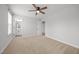 Carpeted bedroom with neutral walls, a ceiling fan, and access to a bathroom at 525 Marion Hills Way, Knightdale, NC 27545
