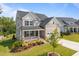 Beautiful two-story home with well-kept lawn, garden bed, stone accents, and a welcoming front porch at 525 Marion Hills Way, Knightdale, NC 27545