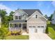 Charming two-story home with a covered front porch and well-maintained landscaping at 525 Marion Hills Way, Knightdale, NC 27545