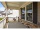 Charming front porch showcasing stone accents, white railings, and views of the surrounding neighborhood at 525 Marion Hills Way, Knightdale, NC 27545