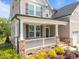 Inviting front porch with stone base, white railings, and a view of the beautifully landscaped yard at 525 Marion Hills Way, Knightdale, NC 27545