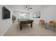 Bright game room featuring a pool table, comfortable seating, and a ceiling fan for added comfort at 525 Marion Hills Way, Knightdale, NC 27545
