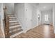 Inviting hallway with decorative stair treads and an adjacent entry door at 525 Marion Hills Way, Knightdale, NC 27545