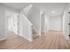 Inviting hallway featuring stairs with wood flooring and white trim at 525 Marion Hills Way, Knightdale, NC 27545