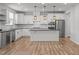 Modern kitchen with stainless steel appliances, a central island and decorative pendant lighting at 525 Marion Hills Way, Knightdale, NC 27545