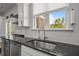 A stainless steel sink is surrounded by dark countertops in this kitchen at 525 Marion Hills Way, Knightdale, NC 27545
