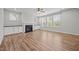 Living room showcasing a fireplace with white cabinetry and large windows overlooking the backyard at 525 Marion Hills Way, Knightdale, NC 27545