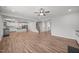 Bright, open-concept living room with hardwood floors and an adjoining kitchen and staircase at 525 Marion Hills Way, Knightdale, NC 27545