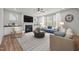 Bright living room featuring a fireplace, large windows, and modern furnishings at 525 Marion Hills Way, Knightdale, NC 27545