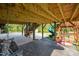 Open patio area with wooden beams, outdoor swing, and playset; great for relaxation and fun at 525 Marion Hills Way, Knightdale, NC 27545