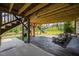 View of covered patio with swings, outdoor furniture, and view of backyard playset and garden at 525 Marion Hills Way, Knightdale, NC 27545