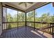 View of screened porch with wooden floors, ceiling fan, and view of the backyard at 525 Marion Hills Way, Knightdale, NC 27545