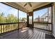 View of screened porch with wooden floors, ceiling fan, and outdoor view at 525 Marion Hills Way, Knightdale, NC 27545