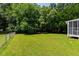 Expansive backyard featuring a large lawn, privacy fence, and convenient storage shed, perfect for outdoor living at 5413 Lower Creek Ct, Apex, NC 27539