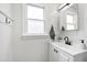 Bright bathroom features a modern vanity, white cabinets, and a window with natural light at 5413 Lower Creek Ct, Apex, NC 27539