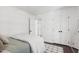 Bedroom with white walls, dark wood floors and a large mirror at 5413 Lower Creek Ct, Apex, NC 27539