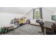 Upstairs bonus room with white sofa and desk area at 5413 Lower Creek Ct, Apex, NC 27539