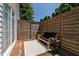 Cozy outdoor patio with a wooden deck, bench, stylish rug, and privacy screen, offering a private retreat at 5413 Lower Creek Ct, Apex, NC 27539