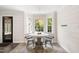Bright dining area with a round table set by bay windows and modern decor at 5413 Lower Creek Ct, Apex, NC 27539