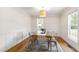 Elegant dining room with a wood table, modern chairs, wainscoting, and stylish light fixture at 5413 Lower Creek Ct, Apex, NC 27539