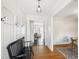 Bright entryway with hardwood floors, paneled walls, and a bench for seating at 5413 Lower Creek Ct, Apex, NC 27539