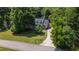 Charming home with a beautiful lawn, surrounded by mature trees, and a curved driveway at 5413 Lower Creek Ct, Apex, NC 27539