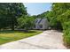Charming home with a long driveway, well-maintained lawn, mature trees, and classic architectural details at 5413 Lower Creek Ct, Apex, NC 27539