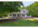 Traditional-style home featuring a well-manicured lawn, mature trees, dormers, and charming curb appeal at 5413 Lower Creek Ct, Apex, NC 27539