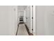 Hallway leads to the bedroom showcasing the flooring, neutral walls, and white doors at 5413 Lower Creek Ct, Apex, NC 27539