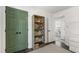 Hallway view with green doors, a bookshelf, and a bedroom at the end at 5413 Lower Creek Ct, Apex, NC 27539