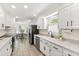 Modern kitchen featuring white cabinets, stainless appliances, and a view to the dining area at 5413 Lower Creek Ct, Apex, NC 27539