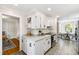 Charming kitchen with white cabinetry, modern appliances, and an open layout at 5413 Lower Creek Ct, Apex, NC 27539