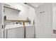 Functional laundry room includes a washer, dryer, and shelving for storage solutions at 5413 Lower Creek Ct, Apex, NC 27539