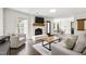 Cozy living room with fireplace, comfortable seating, and an open layout to the dining area at 5413 Lower Creek Ct, Apex, NC 27539