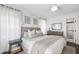 Neutral main bedroom featuring a comfy bed, a dresser and sheer curtains for natural light at 5413 Lower Creek Ct, Apex, NC 27539