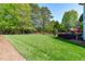 Beautifully landscaped backyard with mature trees, well-manicured lawn, and ample space for recreation at 6004 Brass Tack Ct, Fuquay Varina, NC 27526