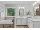 Bright bathroom featuring double vanity, garden tub, and natural light at 6004 Brass Tack Ct, Fuquay Varina, NC 27526