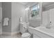 Bright bathroom with dual sinks, tile flooring, and a window for natural light at 6004 Brass Tack Ct, Fuquay Varina, NC 27526