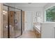 Tiled bathroom featuring a walk-in shower, soaking tub, and natural light at 6004 Brass Tack Ct, Fuquay Varina, NC 27526