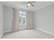 Neutral bedroom with a ceiling fan, large window, and natural light at 6004 Brass Tack Ct, Fuquay Varina, NC 27526