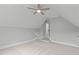 Bedroom featuring neutral walls, carpet flooring, a ceiling fan, and multiple doorways at 6004 Brass Tack Ct, Fuquay Varina, NC 27526