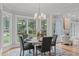 Cozy dining area with bay windows offering lovely backyard views, chandelier, and inviting seating at 6004 Brass Tack Ct, Fuquay Varina, NC 27526