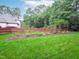 Large garden with lush greenery, healthy vegetables, and rustic garden supports at 6004 Brass Tack Ct, Fuquay Varina, NC 27526
