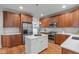Well-appointed kitchen with stainless steel appliances, custom cabinets, and central island featuring great natural light at 6004 Brass Tack Ct, Fuquay Varina, NC 27526