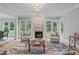 Inviting living room featuring a fireplace, large windows, and comfortable seating, enhancing its warmth at 6004 Brass Tack Ct, Fuquay Varina, NC 27526