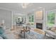 Open-concept living area with fireplace, hardwood floors, and a dining room view at 6004 Brass Tack Ct, Fuquay Varina, NC 27526